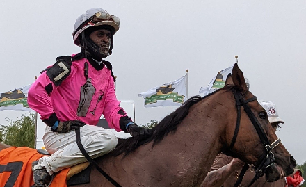 Chris-Husbands Jockey Patrick Husbands holding trophy after winning title at Fort Erie racetrack