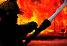 BELIZE-Mother and son killed in early morning blaze, arsonist detained. Forensic investigators at the scene of a fatal house fire in Belize.