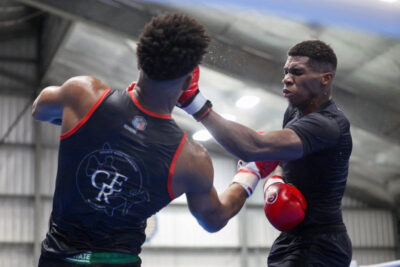 Cyril Koffi (right) delivers a knockout punch to Isaac Castard Boxer Koffi celebrating victory at Guadeloupe International Boxing Open