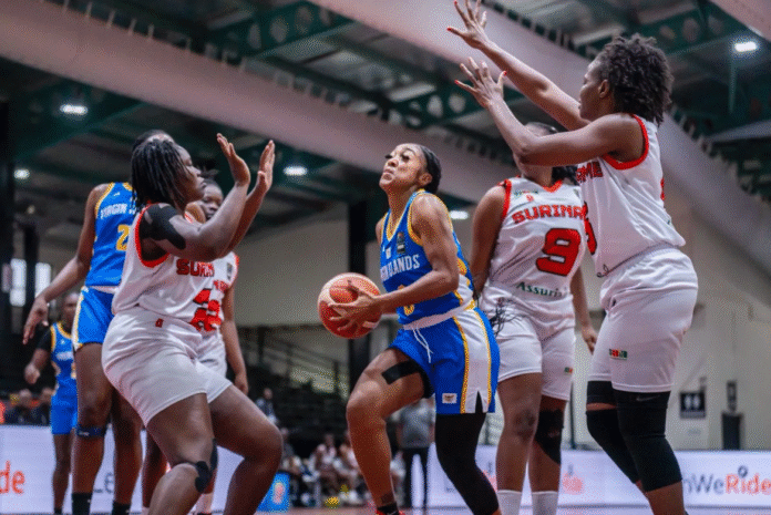 U.S. Virgin Islands women's basketball team player driving to the hoop against Suriname.