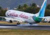 TRINIDAD-CAL to discontinue flights to some Caribbean destinations. Caribbean Airlines aircraft on tarmac with route map changes displayed