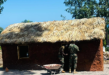 JAMAICA-Ghana hands over traditional homes to Jamaica. Jamaica Culture Minister Olivia Grange and Foreign Affairs Minister Kamina Johnson-Smith stand with Ghana Army Colonel Emmanuel Asia at Seville Heritage Park in St Ann during official handover ceremony of two traditional African mud houses with open kitchen constructed by Ghana Army Reconstruction Team
