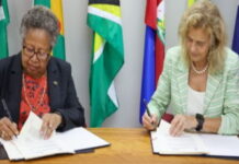 CARIBBEAN-CARICOM and Spain advance development cooperation. CARICOM and Spanish officials shaking hands at cooperation signing