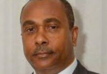 ANTIGUA-Advisor says UPP ignored opinion poll results ahead of general election. Political advisor speaking into microphone with opinion poll charts in background
