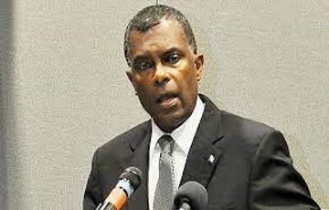 Bahamas May Not Support Controversial Net-Zero Shipping Framework Cargo ships anchored near Nassau, Bahamas, under cloudy skies as environmental policies are debated.