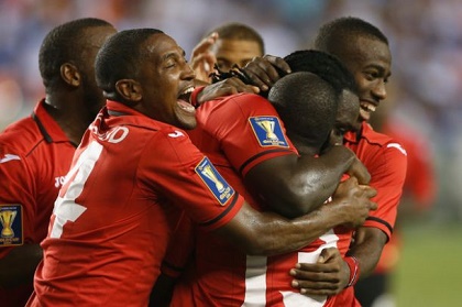 T&T Stalwarts Rally Behind National Football Team for World Cup Push Trinidad and Tobago national football team players huddle together during World Cup qualifying preparations.