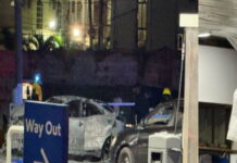 GUYANA-Suspect being hunted as explosion kills one, injures several others. Police investigators at the scene of an explosion in Guyana