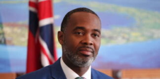 BERMUDA-Premier Burt is attending meetings in the United Kingdom. Bermuda Premier David Burt at UK diplomatic meetings table.