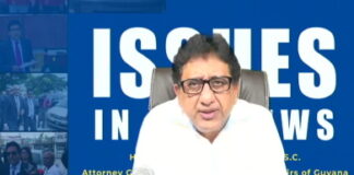 GUYANA-Government says E-ID information will be protected by legislation. Guyana government officials presenting electronic identification legislation document.