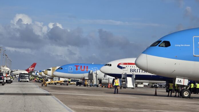 Barbados airport terminal bustling with winter holiday passengers.