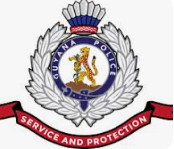 GPFs Guyana police officer being escorted by colleagues during internal investigation.