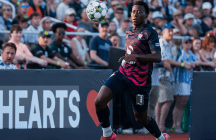Barbadian footballer Reid-Stephen signs contract with New Mexico United, holds jersey