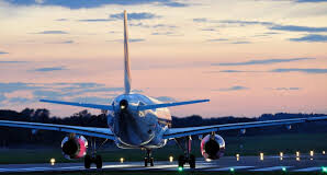 CARIBBEAN-Restrictions lifted on flights from the US to the Caribbean and South America. Airplane flying over tropical Caribbean beach coastline