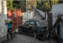 CMCFeature-UN Report warns child trafficking by gangs is putting Haiti’s future at risk. Haitian children fleeing gang violence carry belongings along roadside as UN report warns child trafficking by criminal gangs is putting Haiti's future at risk