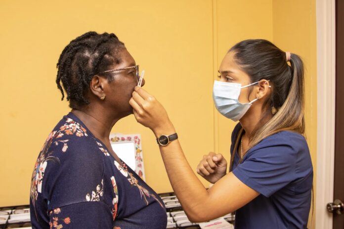 Guyana Health Minister Dr Frank Anthony signs Memorandum of Understanding with 67 private healthcare providers at Herdmanston Lodge in Georgetown to expand eye care vouchers to all citizens for free testing and spectacles