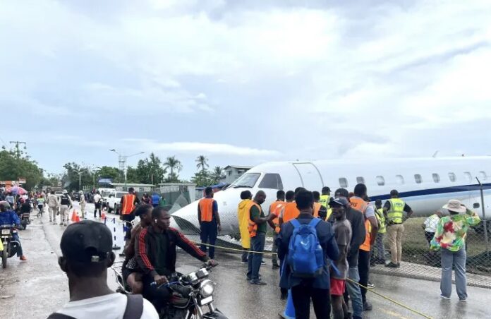 An IBC Airways Embraer 145 aircraft rests off the runway on the northeast shoulder near National Road 7 at Antoine-Simon Airport in Les Cayes, Haiti, after veering off during landing in heavy rain on March 20, 2026