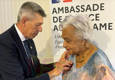 McLeod-award French Ambassador Nicolas de Lacoste pins the Legion of Honour medal on Surinamese writer Cynthia Mc Leod-Ferrier at the French Residence ceremony as family and friends attend on March 2 2026