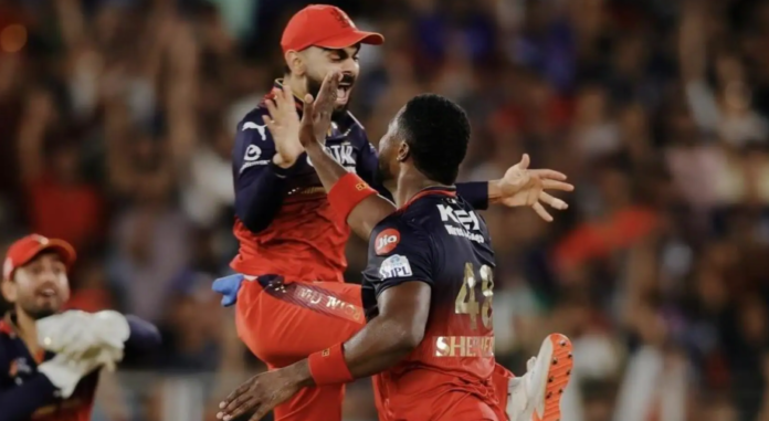 West Indies all-rounder Romario Shepherd celebrates after taking three wickets for Royal Challengers Bengaluru during the IPL 2026 opener against Sunrisers Hyderabad at M Chinnaswamy Stadium on March 28, 2026, finishing with figures of 3-54