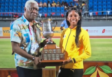 ATHLETICS-Jamaica romps to 40th title; Douglas claims Austin Sealy Award. Jamaican team celebrating with 40th CARIFTA trophy as Douglas holds Austin Sealy Award