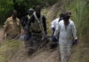 BELIZE-Police awaiting autopsy as body of second missing person found. Belize police officers near scene where second missing person's body was discovered