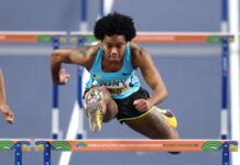 ATHLETICS-UPDATE Charlton equals world record en route to third hurdles title.