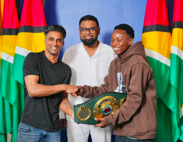 Elton Dharry in boxing ring with IBO title belt on the line and home crowd cheering