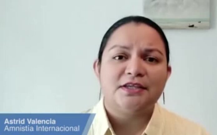 Amnesty International report on Haiti massacre with officials reviewing evidence