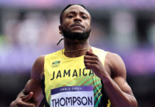 ATHLETICS-Sprint legend predicts standout year for Thompson. Sprint legend speaking at podium with Thompson's photo on screen