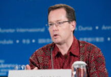 CARIBBEAN-Warning for tourism-dependent countries. Economic chart showing tourism revenue decline with Caribbean map in background