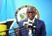 ST. LUCIA-ST. Lucia PM on the sovereign welfare fund and the future of CARICOM. St. Lucia Prime Minister speaking at podium with Sovereign Welfare Fund and CARICOM flags in background