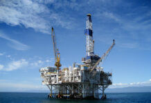 JAMAICA-Oil exploration could begin offshore Jamaica in two years. Offshore oil rig near Jamaica coast with sunset in background