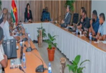 SURINAME-Government and union met on issues affecting air traffic controllers. Government officials and union representatives seated at negotiation table