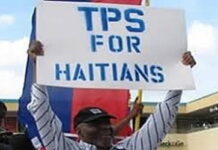 UNITED STATES- Supreme Court urged to uphold the legal status of Haitian immigrants. Protesters holding signs outside Supreme Court defending Haitian immigrant legal status