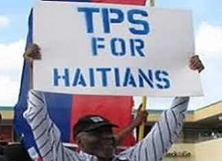 UNITED STATES- Supreme Court urged to uphold the legal status of Haitian immigrants. Protesters holding signs outside Supreme Court defending Haitian immigrant legal status