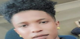 GUYANA-Court awards multi-million dollar compensation to a youth who was unlawfully arrested. Youth standing outside Guyana courthouse with legal papers after compensation ruling