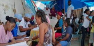 HAITI-Gang violence is affecting the health services for Haitian women and children. Health workers attending to mother and child at clinic amid security concerns in Haiti