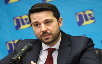 Yasar-Yetiskin Jamaican officials presenting SAF feasibility study charts to stakeholders in meeting room