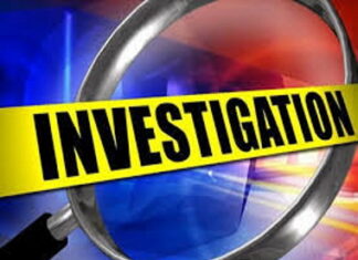 BARBADOS-Police probe death at quarry. Barbados police officers at quarry entrance with yellow tape