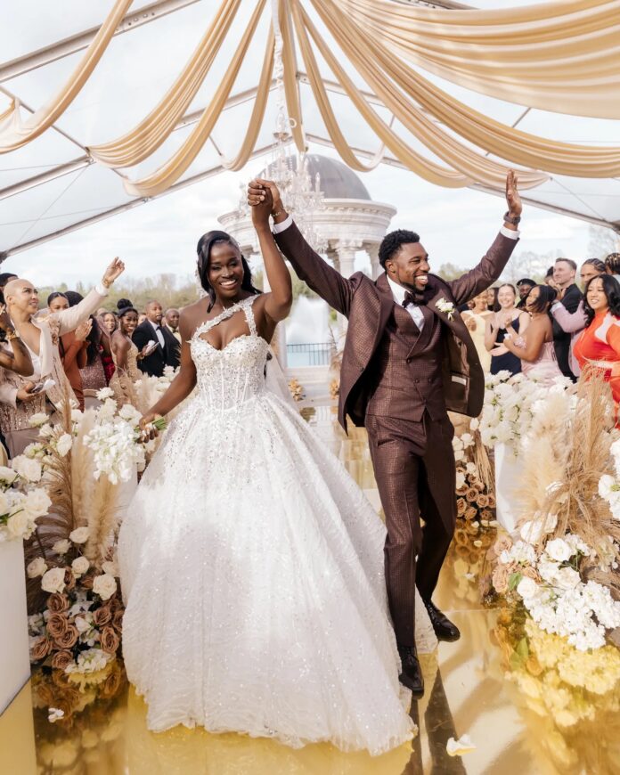 noah-junelle Noah Lyles and Junelle Bromfield kissing at wedding ceremony in Georgia