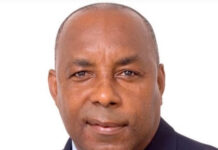 CRICKET-Butcher to receive Lifetime Achievement Award for contribution to sport. Butcher holding Lifetime Achievement Award trophy at cricket ceremony in Barbados