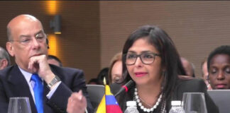 CMCFeature–A pin, a principle, and the integrity of the Caribbean – Territorial claims are decided in Court, not worn on a lapel. Gavel and Caribbean flag with lapel pin beside court documents