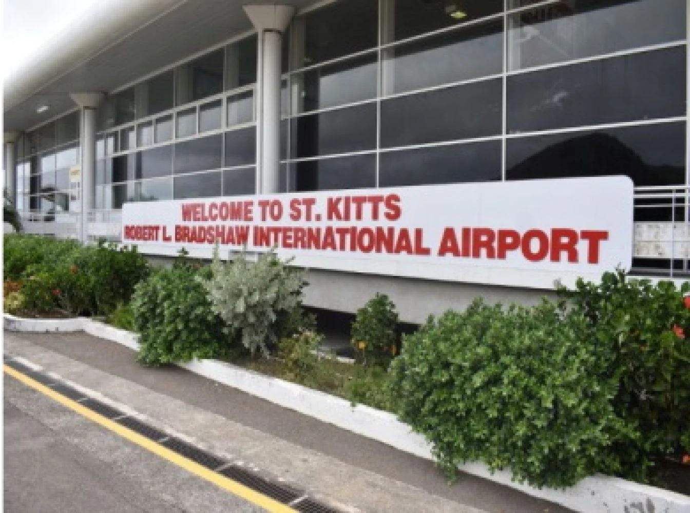 Deportees walking off plane at St. Kitts airport with officials