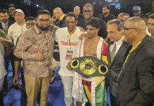 BOXING-Dharry creates history by winning the IBO World title. Elton Dharry holding IBO world title belt in ring with crowd cheering