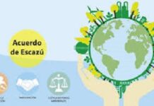 CARIBBEAN-Escazú in the Caribbean: Turning commitments into action. Caribbean officials signing Escazú Agreement documents with environmental backdrop