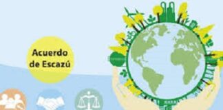 CARIBBEAN-Escazú in the Caribbean: Turning commitments into action. Caribbean officials signing Escazú Agreement documents with environmental backdrop