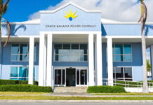 BAHAMAS-Government announces acquisition of Grand Bahama Power Company. Government officials and power company executives shaking hands after acquisition deal