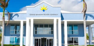 BAHAMAS-Government announces acquisition of Grand Bahama Power Company. Government officials and power company executives shaking hands after acquisition deal
