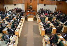JAMAICA-Government gets green light for NaRRA legislation. Jamaica parliament chamber with NaRRA bill approved on screen