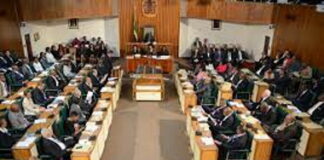JAMAICA-Government gets green light for NaRRA legislation. Jamaica parliament chamber with NaRRA bill approved on screen