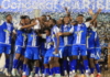 FOOTBALL-Three teams already locked in as 2026 Caribbean Cup draw date set. Caribbean Cup trophy with three team flags and calendar marking draw date